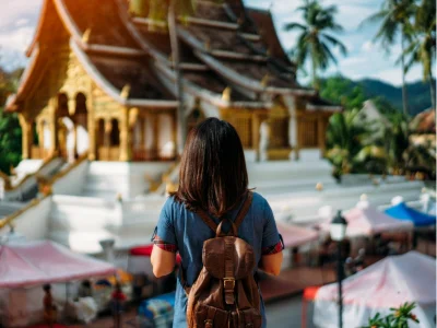 Een vrouw bewondert een tempel in Luang Prabang, Laos